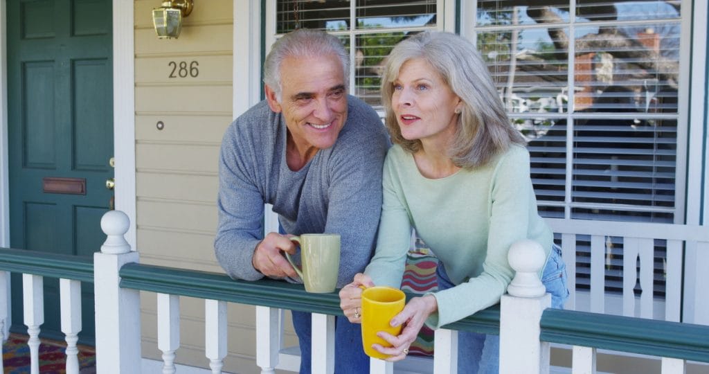 senior couple front porch coffee