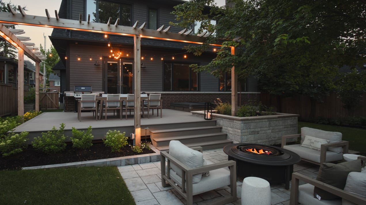 backyard wild ridge landscapes pergola night lighting ottawa outdoor spaces fire pit patio deck retaining wall