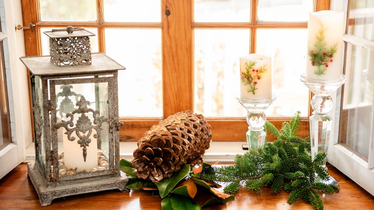 sue pitchforth last-minute festive touches christmas decor windowseill hurrican lantern giant pinecone candles